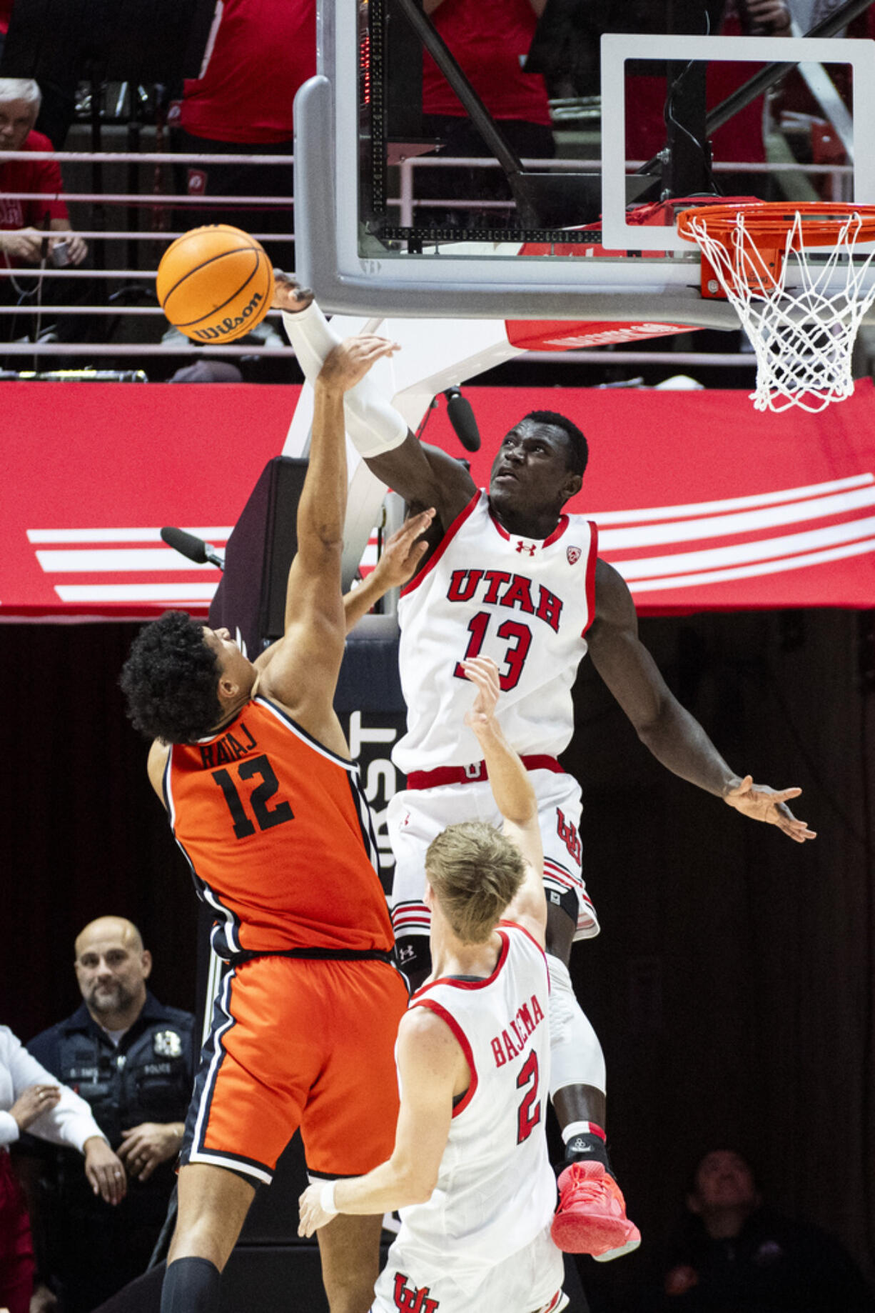 Utah center Keba Keita (13) blocks a shot by Oregon State forward Michael Rataj (12) during the second half of an NCAA college basketball game Thursday, Jan. 18, 2024, in Salt Lake City.