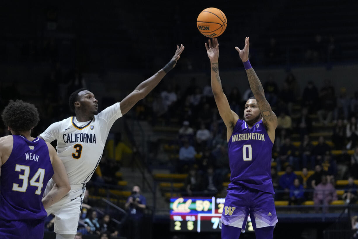 Washington guard Koren Johnson, right, shoots a 3-pointer next to California guard Keonte Kennedy (3) during the second half of an NCAA college basketball game Thursday, Jan. 18, 2024, in Berkeley, Calif. (AP Photo/Godofredo A.