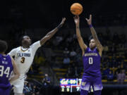 Washington guard Koren Johnson, right, shoots a 3-pointer next to California guard Keonte Kennedy (3) during the second half of an NCAA college basketball game Thursday, Jan. 18, 2024, in Berkeley, Calif. (AP Photo/Godofredo A.