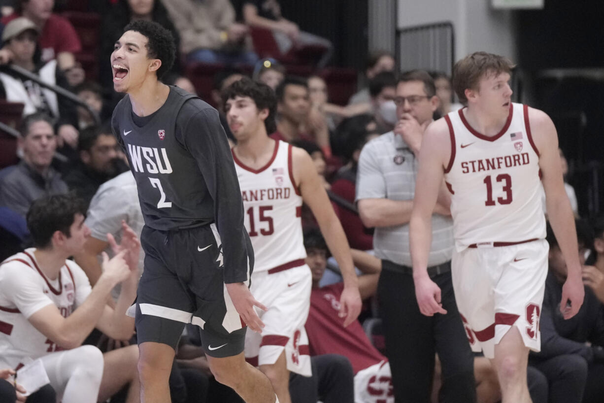 Washington State guard Myles Rice (2) reacts after making a 3-point basket, next to Stanford guard Benny Gealer (15), coach Jerod Haase, second from right, and guard Michael Jones (13) during the first half of an NCAA college basketball game in Stanford, Calif., Thursday, Jan. 18, 2024.