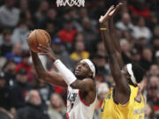 Portland Trail Blazers forward Jerami Grant, left, drives to the basket as Indiana Pacers forward Pascal Siakam defends during the first half of an NBA basketball game Friday, Jan. 19, 2024, in Portland, Ore.