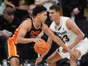 Oregon State forward Michael Rataj, left, drives past Colorado forward Tristan da Silva, right, in the second half of an NCAA college basketball game Saturday, Jan. 20, 2024, in Boulder, Colo.