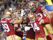 San Francisco 49ers running back Christian McCaffrey (23) celebrates his rushing touchdown with teammates during the second half of an NFL football NFC divisional playoff game against the Green Bay Packers Saturday, Jan. 20, 2024, in Santa Clara, Calif.