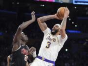 Los Angeles Lakers forward Anthony Davis, right, shoots as Portland Trail Blazers center Duop Reath defends during the first half of an NBA basketball game Sunday, Jan. 21, 2024, in Los Angeles. (AP Photo/Mark J.