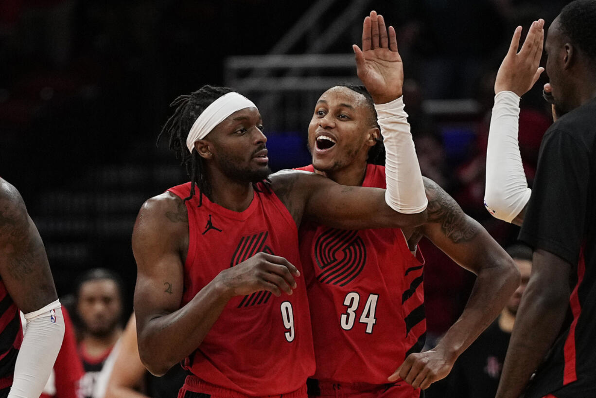 Portland Trail Blazers forward Jerami Grant is congratulated by Jabari Walker after hitting a 3-pointer at the buzzer to send the game against the Houston Rockets to overtime, Wednesday, Jan. 24, 2024, in Houston. (AP Photo/Kevin M.