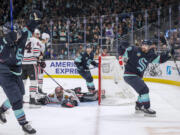 Seattle Kraken left wing Tomas Tatar, right, celebrates  a goal by left wing Brandon Tanev, left, on Chicago Blackhawks goaltender Arvid Soderblom during the second period of an NHL hockey game Wednesday, Jan. 24, 2024, in Seattle.