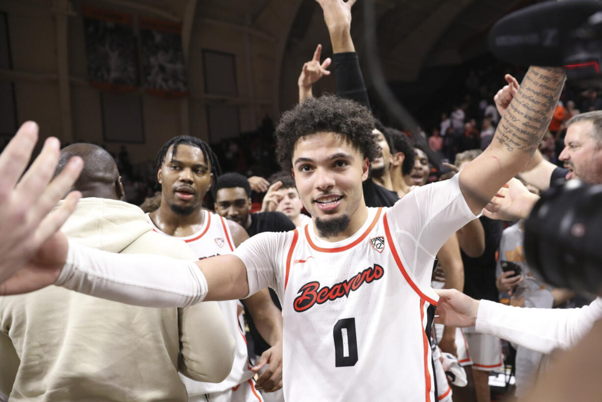 Oregon State guard Jordan Pope, center, celebrates his game-winning, 3-point basket against Arizona in an NCAA college basketball game Thursday, Jan. 25, 2024, in Corvallis, Ore. Oregon State won 83-80.