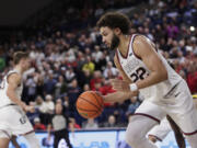 Gonzaga forward Anton Watson controls the ball during the second half of an NCAA college basketball game against San Francisco, Thursday, Jan. 25, 2024, in Spokane, Wash.