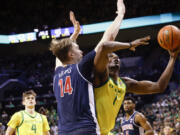 Oregon center N'Faly Dante (1), shoots against Arizona center Motiejus Krivas (14) during the first half of an NCAA college basketball game in Eugene, Ore., Saturday, Jan. 27, 2024.