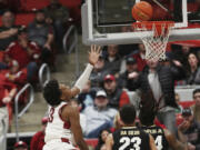 Washington State forward Isaac Jones, left, shoots during the second half of an NCAA college basketball game against Colorado, Saturday, Jan. 27, 2024, in Pullman, Wash. Washington State won 78-69.