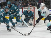 San Jose Sharks left wing William Eklund (72) reaches for the puck against Seattle Kraken right wing Eeli Tolvanen (20) during the second period of an NHL hockey game in San Jose, Calif., Tuesday, Jan. 30, 2024.