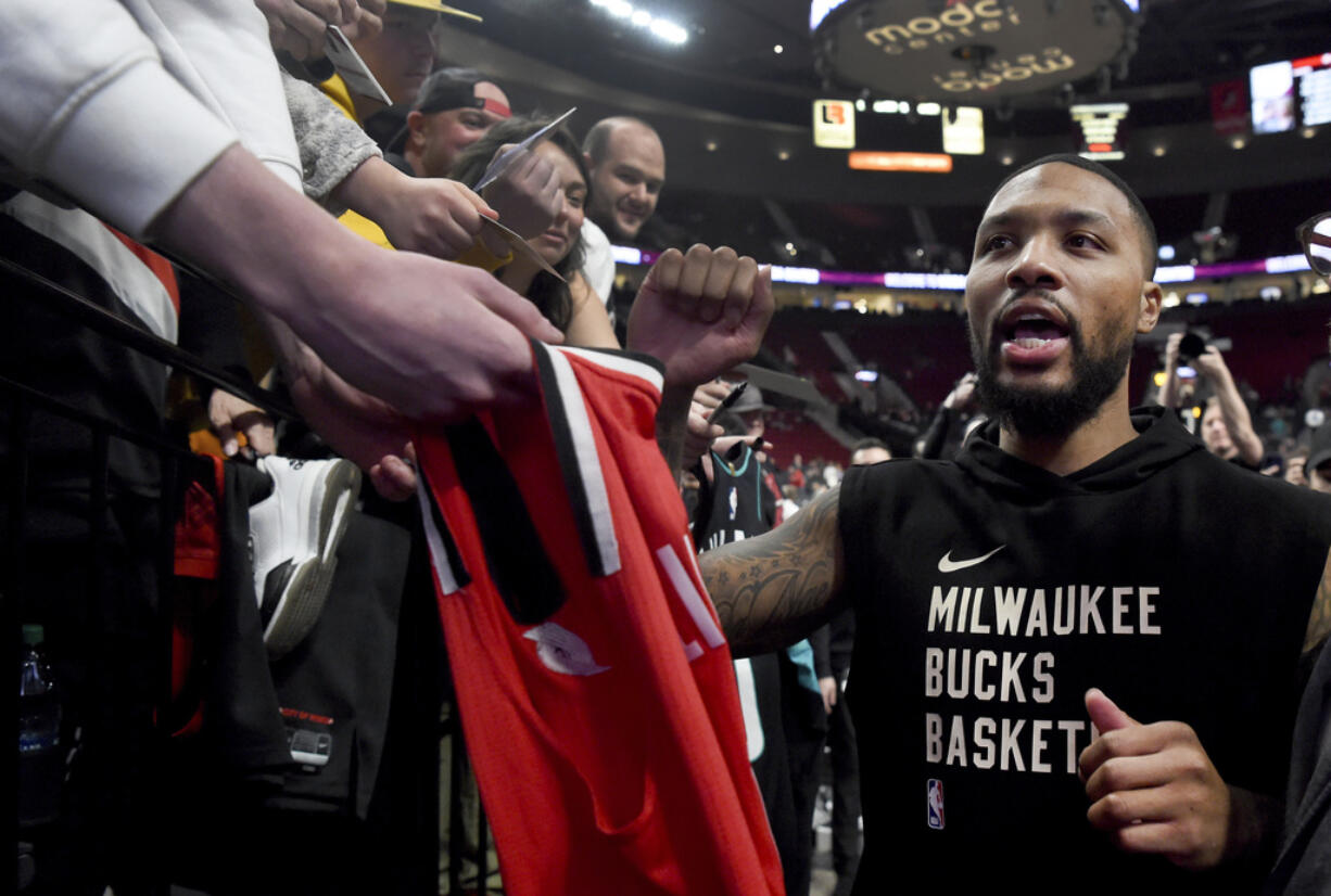 Milwaukee Bucks guard Damian Lillard runs off the court after warmups before an NBA basketball game against the Portland Trail Blazers in Portland, Ore., Wednesday, Jan. 31, 2024.