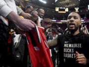 Milwaukee Bucks guard Damian Lillard runs off the court after warmups before an NBA basketball game against the Portland Trail Blazers in Portland, Ore., Wednesday, Jan. 31, 2024.