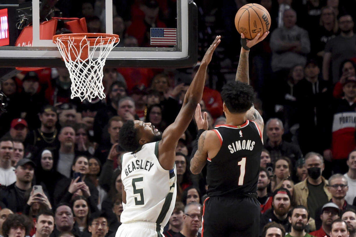 Portland Trail Blazers guard Anfernee Simons (1) hits a shot over Milwaukee Bucks guard Malik Beasley (5) late in the second half of an NBA basketball game in Portland, Ore., Wednesday, Jan. 31, 2024.