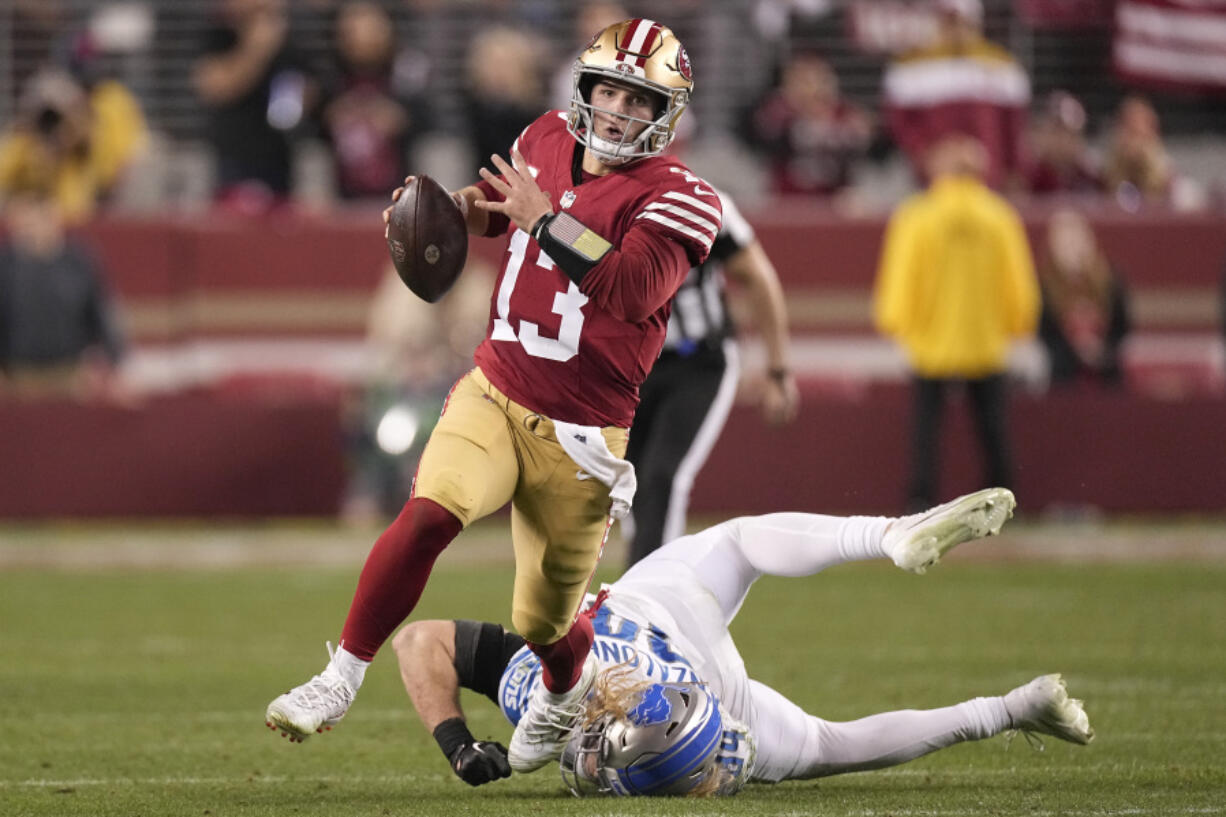 San Francisco 49ers quarterback Brock Purdy (13) runs against Detroit Lions linebacker Alex Anzalone during the second half of the NFC Championship NFL football game in Santa Clara, Calif., Sunday, Jan. 28, 2024. (AP Photo/Mark J.