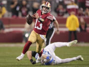 San Francisco 49ers quarterback Brock Purdy (13) runs against Detroit Lions linebacker Alex Anzalone during the second half of the NFC Championship NFL football game in Santa Clara, Calif., Sunday, Jan. 28, 2024. (AP Photo/Mark J.