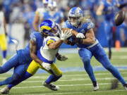 Detroit Lions cornerback Cameron Sutton (1) deflects a pass intended for Los Angeles Rams wide receiver Puka Nacua (17) during the second half of an NFL wild-card playoff football game, Sunday, Jan. 14, 2024, in Detroit.