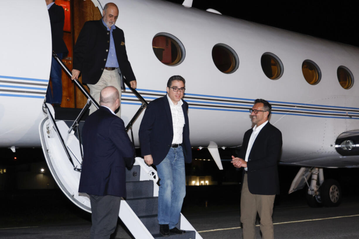 U.S. Special Presidential Envoy for Hostage Affairs Roger Carstens, right, greets freed Americans Siamak Namazi, Morad Tahbaz and Emad Shargi, as well as two returnees whose names have not yet been released by the U.S. government, who were released in a prisoner swap deal between U.S and Iran, as they arrive at Davison Army Airfield, Sept. 19, 2023 at Fort Belvoir, Va. By any standard, the past 18 months have been remarkable for getting wrongfully detained Americans home. There were major swaps with adversaries like Iran and Russia, including one that secured the freedom of WNBA star Brittney Griner, and a large prisoner exchange just last month with Venezuela.