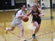 Olivia Carroll of Hudson’s Bay (11) dribbles against Addilyn Gibbons of Washougal (3) during a 2A Greater St. Helens League girls basketball game at Hudson’s Bay High School on Monday, Jan. 29, 2024.