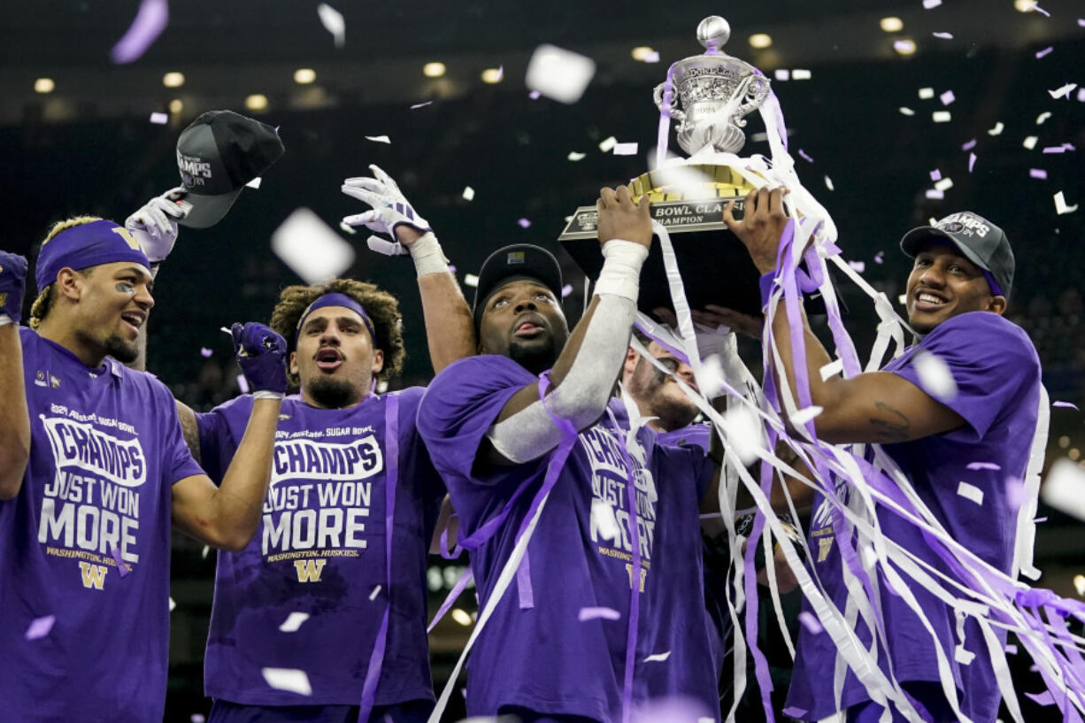 Washington players celebrate victory after the Sugar Bowl CFP NCAA semifinal college football game between Washington and Texas, Tuesday, Jan. 2, 2024, in New Orleans. Washington won 37-31.