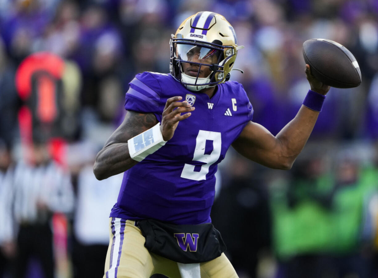 File - Washington quarterback Michael Penix Jr. looks to throw against Washington State during the second half of an NCAA college football game Nov. 25, 2023, in Seattle. The biggest Washington players allowed only 11 sacks this season, paving the way for Penix and No. 2 Huskies to reach the College Football Playoff and earning the Joe Moore Award as the best offensive line in the country.