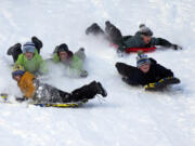 Youths slide on snow at Pippy Park in St. John&#039;s, Newfoundland and Labrador, Canada, on Saturday, Jan. 6, 2024, following the first significant snow storm of the winter.