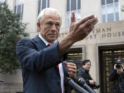 Former Trump White House official Peter Navarro talks to the media as he arrives at U.S. Federal Courthouse in Washington, Thursday, Jan. 25, 2024.