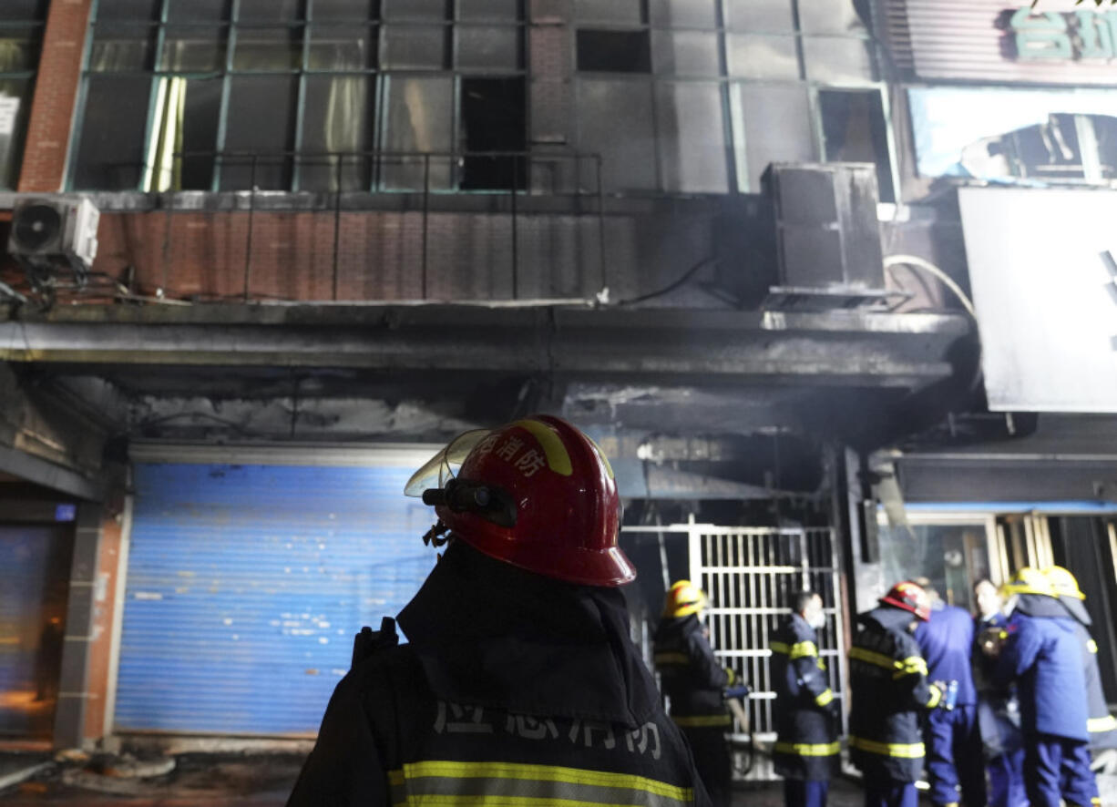 Firefighters work at the site of a building fire in Xinyu City, east China&rsquo;s Jiangxi Province, Wednesday, Jan. 24, 2024. Chinese state media say at least 39 people died and nine others were injured after a fire broke out in southeastern Jiangxi province. State broadcaster CCTV reported that local authorities said that the fire broke out Wednesday afternoon. The building houses an internet cafe in the basement and tutoring centers on upper floors. Local government officials were deployed to the scene in addition to first responders.