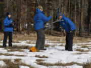 FILE - Sean de Guzman, right, snow survey manager at the California Department of Water Resources, conducts the first snow survey of the season with his team at Phillips Station, Calif., on Tuesday, Jan. 2, 2024. Once regularly snowbound river basins across the globe are increasingly seeing their snowpack shrink and climate change is to blame, a new study found.