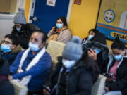 Luisa from Colombia waits with others for medical treatment at the Plaza Del Sol Family Health Center in the Queens borough in New York, Thursday, Jan. 11, 2024.