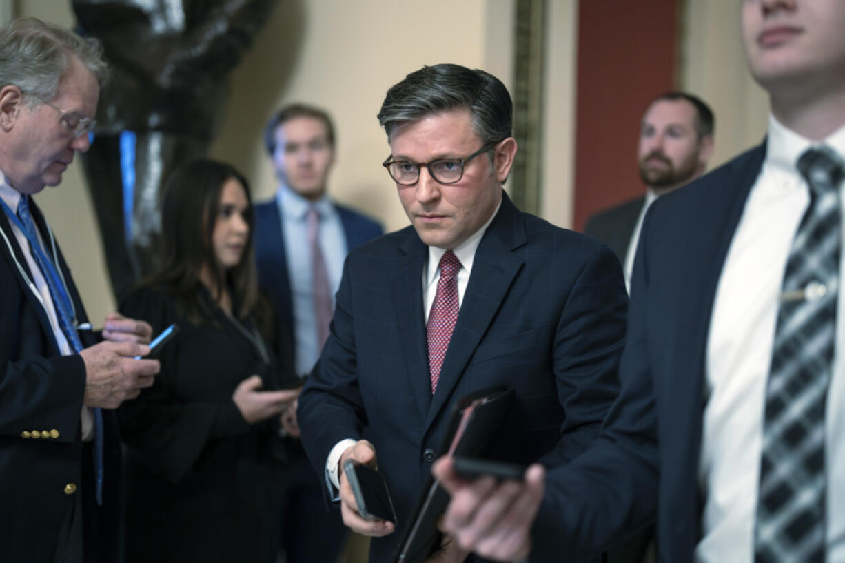 Speaker of the House Mike Johnson, R-La., heads to the chamber at the Capitol in Washington, Friday, Jan. 12, 2024. (AP Photo/J.