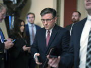 Speaker of the House Mike Johnson, R-La., heads to the chamber at the Capitol in Washington, Friday, Jan. 12, 2024. (AP Photo/J.