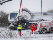 Rescuers try to recover a truck that slided off road during a heavy snowfall in Viborg, central Jutland, Denmark, Wednesday Jan. 3, 2024. Temperatures have fallen below minus 40 degrees Celsius in the Nordic region for a second day in a row, with the coldest January temperature recorded in Swedish Lapland in 25 years. The weather -&ndash; cold with snow and gale-force winds -- has disrupted transportation throughout the Nordic region, with several bridges closed and some train and ferry services suspended.