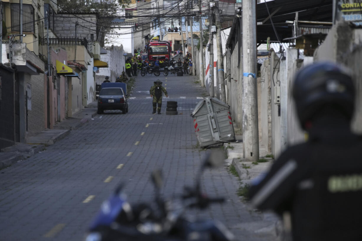 Police carry out a controlled explosion of a suspicious vehicle, parked a block from El Inca prison, in Quito, Ecuador, Wednesday, Jan. 10, 2024.