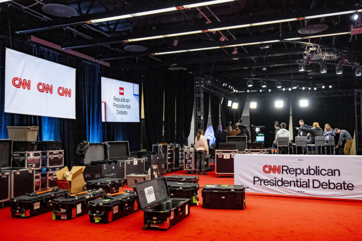 Workers prepare for the Republican presidential debate at Drake University in Des Moines, Iowa, Tuesday, Jan. 9, 2024.