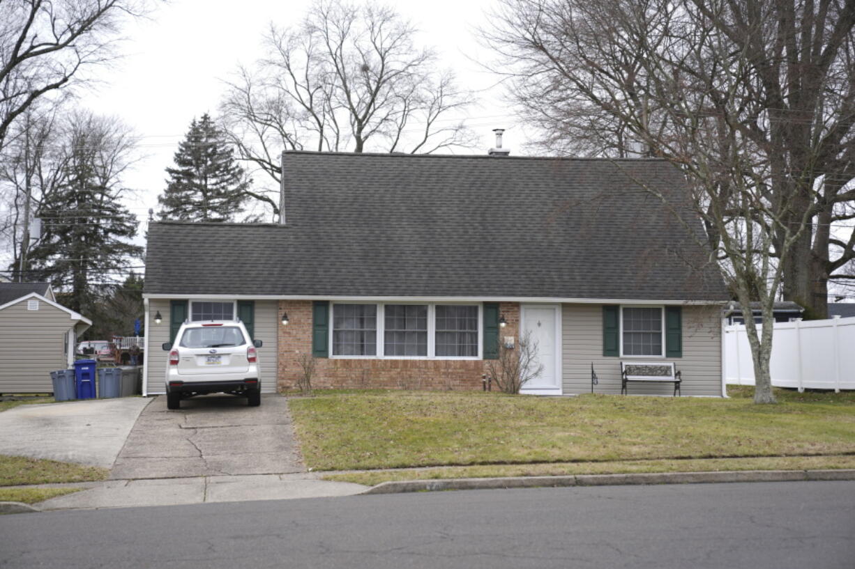 A vehicle is parked in the driveway of a home that was a scene of a murder in Levittown, Pa., on Wednesday, Jan. 31, 2024. A man has been charged with first-degree murder and abusing a corpse after his father was found decapitated. Police are investigating a video on social media that allegedly shows him holding up the head. The father was found beheaded in the bathroom of his home in Levittown, on Tuesday night.