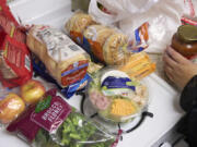 Groceries are displayed on a counter in Bellflower, Calif., on Monday, Feb. 13, 2023. Student and legal advocacy groups are petitioning the U.S. Department of Agriculture to lift the interview requirement for Supplemental Nutrition Assistance Program (SNAP) applicants to receive food aid. SNAP helps low-income families supplement their budgets so they can buy groceries, snacks, and non-alcoholic beverages. An estimated 42 million Americans currently receive the benefits at an average of $212 per person or $401 per household.