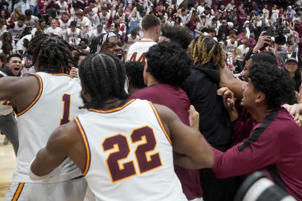 Santa Clara guard Adama Bal, middle left facing, celebrates with teammates and fans after Santa Clara defeated Gonzaga in an NCAA college basketball game in Santa Clara, Calif., Thursday, Jan. 11, 2024.