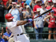 FILE - Texas Rangers&rsquo; Adrian Beltre follows through on a double for his 3,000th career hit which came off a pitch from Baltimore Orioles&rsquo; Wade Miley in the fourth inning of a baseball game, Sunday, July 30, 2017, in Arlington, Texas. Beltr&eacute; could soon be a first-ballot baseball Hall of Fame third baseman. He is among 12 first-timers in consideration for the Class of 2024 that will be revealed Jan. 23.