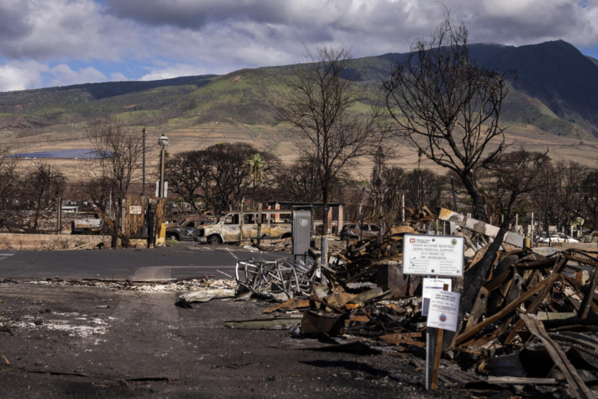 FILE - Debris of former shops and businesses on Front Street in burn zone 11A is pictured Friday, Dec. 8, 2023, in Lahaina, Hawaii. The day after the deadliest U.S. wildfire in a century destroyed a seaside community on Maui, the barrage of 911 calls didn&rsquo;t stop: Reports of missing people, stranded family members and confused tourists trapped without food or water lit up the emergency lines every few minutes, interspersed with reports of new fires starting and older ones flaring back up.