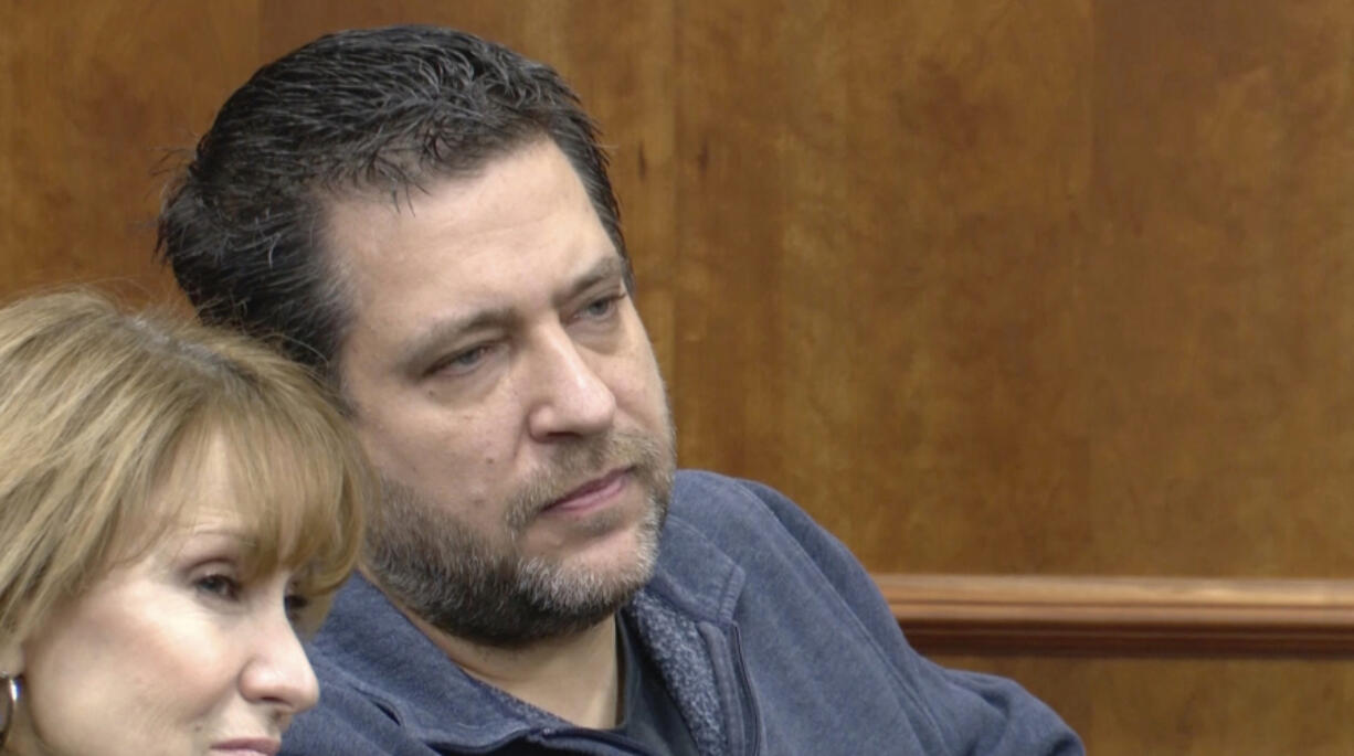 This image taken from video provided by WTVG shows Pastor of Dad&rsquo;s Place Chris Avell, right, sitting inside Bryan Municipal Court on Thursday, Jan. 11, 2024, in Bryan, Ohio. The Christian church filed a federal lawsuit Monday, Jan. 22, after being charged with violating the zoning laws in the northwestern Ohio city by opening up the church around-the-clock for homeless residents and others to find shelter.