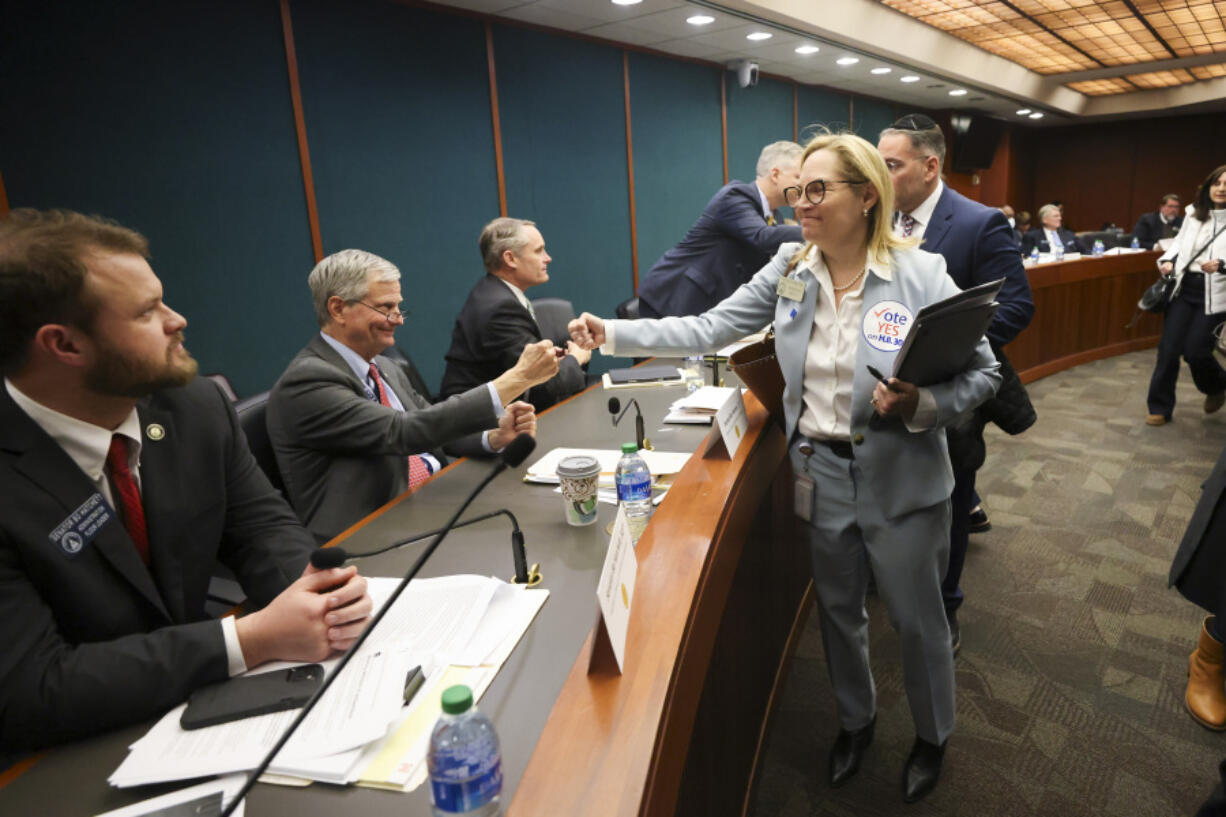 FILE - Rep. Esther Panitch, D-Sandy Springs, right, fist bumps Sen. Ben Watson, R-Savannah, a member of the Senate Judiciary Committee, after House Bill 30, an antisemitism bill, was passed unanimously by the Senate Judiciary Committee in the Coverdell Legislative Office Building, Jan. 22, 2024, in Atlanta. A handful of U.S. states are considering measures that would define antisemitism, but there&rsquo;s debate over whether they would stifle criticism of Israel.