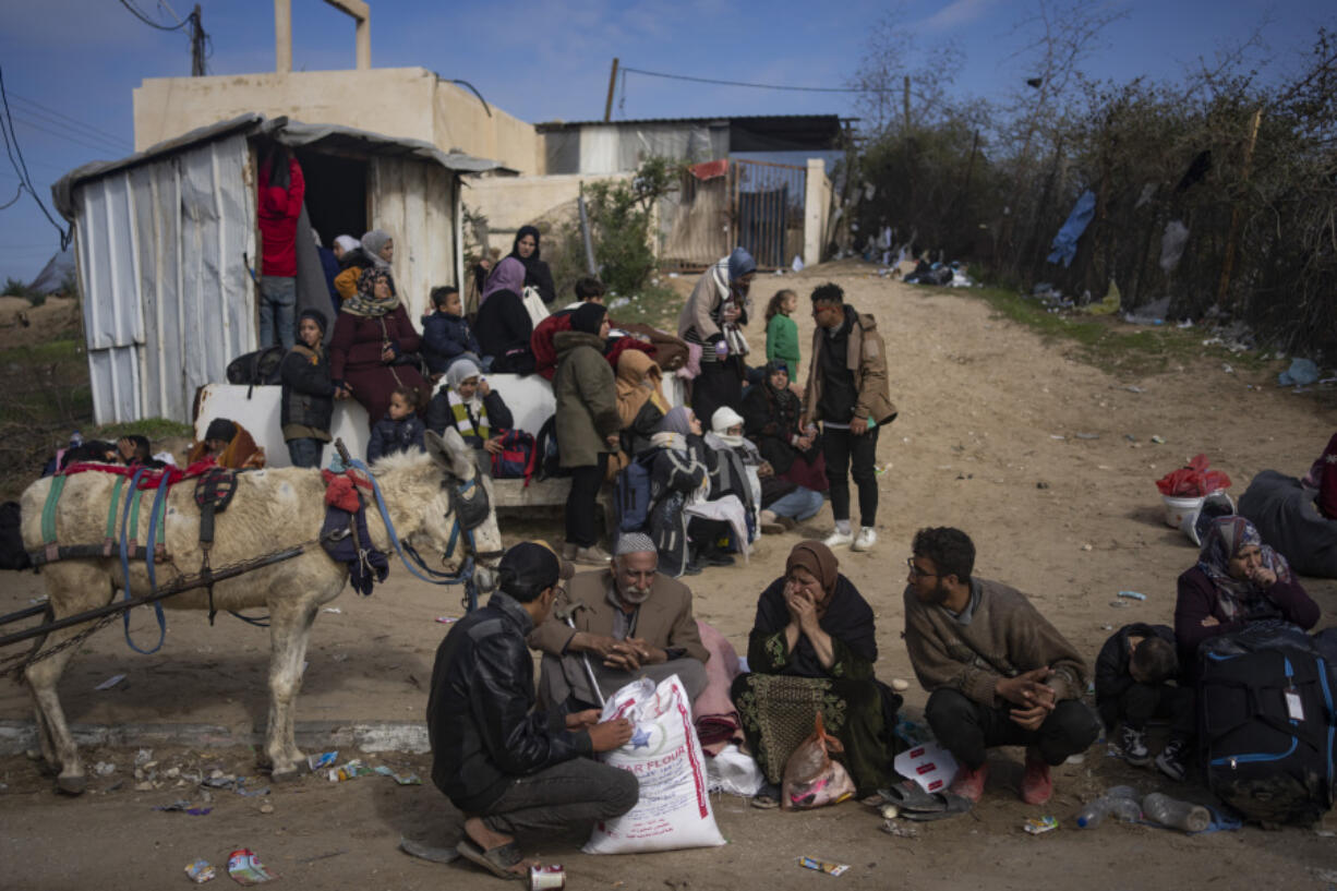 Palestinians arrive in the southern Gaza town of Rafah after fleeing an Israeli ground and air offensive in the nearby city of Khan Younis on Friday, Jan. 26, 2024. Israel has expanded its offensive in Khan Younis, saying the city is a stronghold of the Hamas militant group.