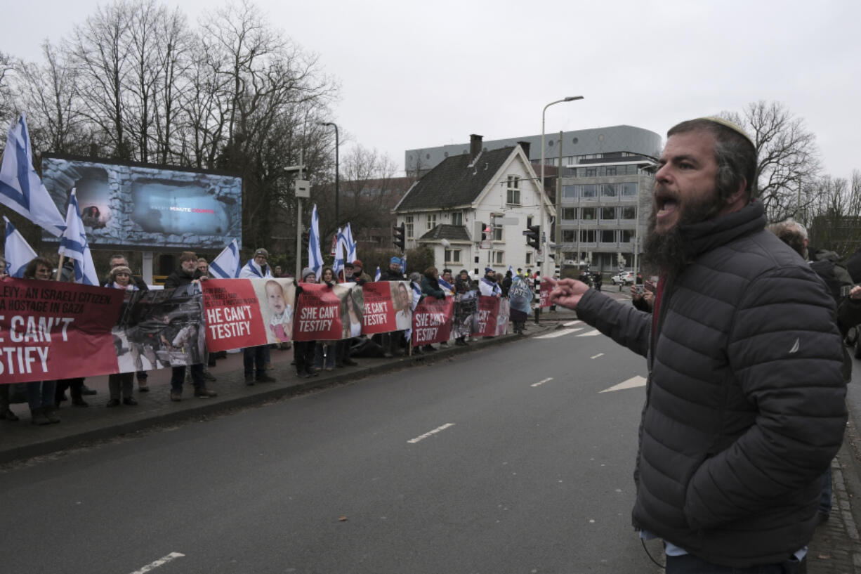 Israeli activist Nati Rom speaks during a protest outside the International Court of Justice in The Hague, Netherlands, Friday, Jan. 12, 2024. The United Nations&rsquo; top court opened hearings Thursday into South Africa&rsquo;s allegation that Israel&rsquo;s war with Hamas amounts to genocide against Palestinians, a claim that Israel strongly denies.