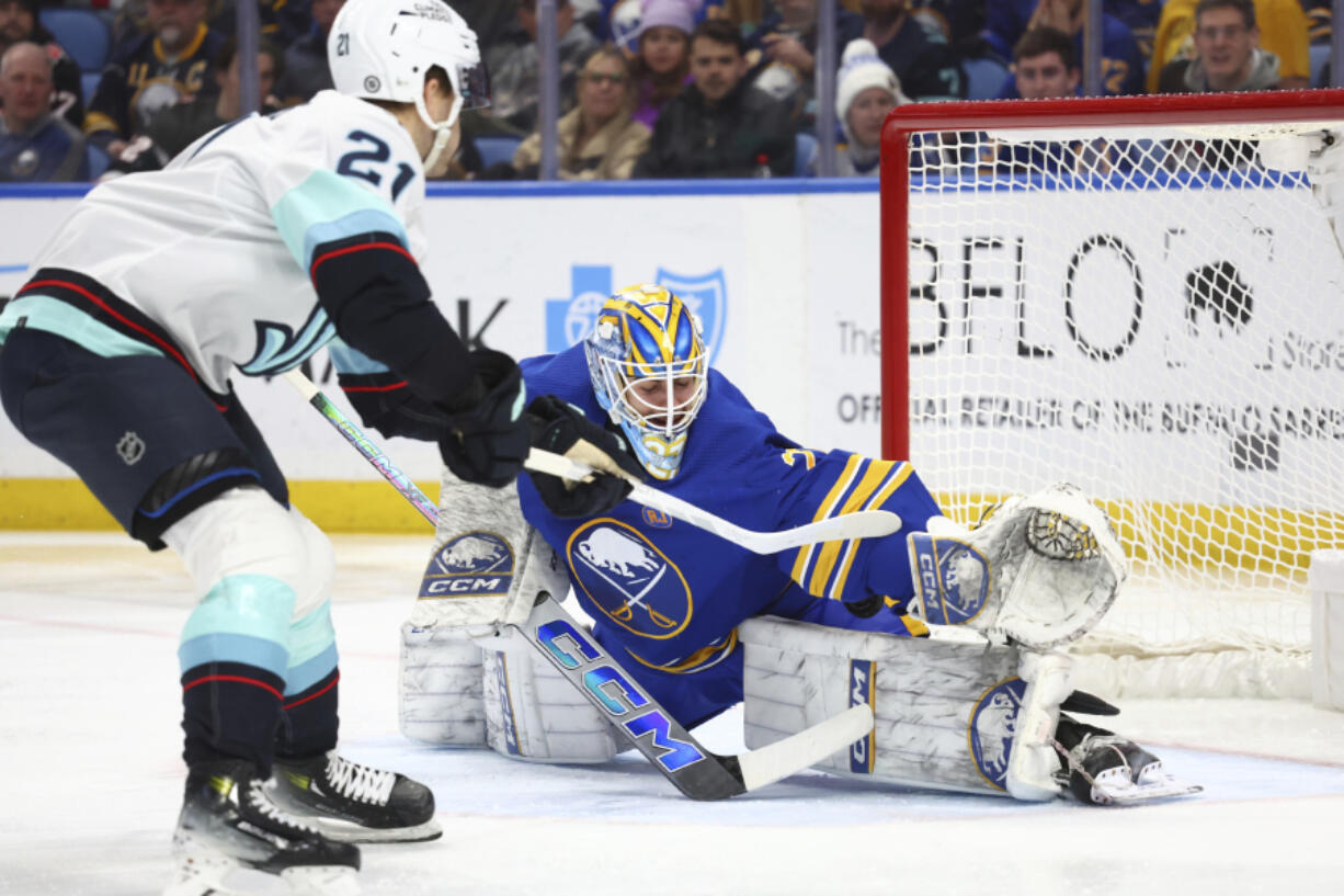 Seattle Kraken center Alex Wennberg (21) puts the puck past Buffalo Sabres goaltender Devon Levi (27) for a goal during the second period of an NHL hockey game Tuesday, Jan. 9, 2024, in Buffalo, N.Y. (AP Photo/Jeffrey T.