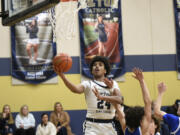 Seton Catholic freshman Kaiden Wilson drives to the basket against La Center during a boys basketball game at Seton Catholic College Prep on Tuesday, Jan. 23, 2024.