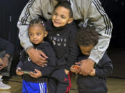 Milwaukee Bucks point guard Damian Lillard poses with his children at an event on Tuesday,  Jan. 30, 2024 in Portland, Ore. Lillard was playing in Portland for the first time since he was traded from the Trail Blazers to the Bucks in the offseason. (AP Photo/Anne M.