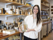 Emily Rodia, owner of Good Buy Supply, holds concentrated laundry soap that customers can pump into their own refillable containers at her store in Philadelphia.