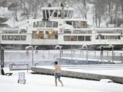 A man walks by the Allas Sea Pool, in Southern Helsinki, Finland, Tuesday, Jan. 2, 2024. Finland and Sweden have recorded this winter&rsquo;s cold records on Tuesday as a temperatures plummeted to over minus 40 degrees as a result of a cold spell prevailing in the Nordic region.