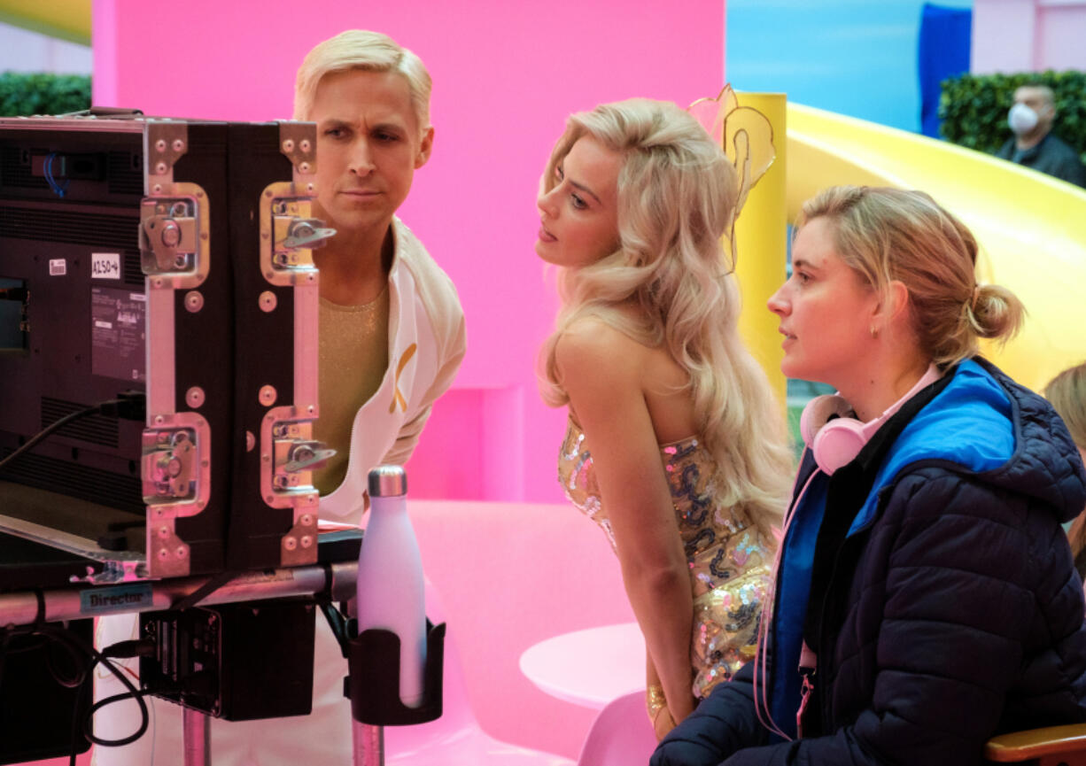 This image released by Warner Bros. Pictures shows actors Ryan Gosling, left, Margot Robbie, center, with director Greta Gerwig on the set of &ldquo;Barbie.&rdquo; (Jaap Buitendijk/Warner Bros.